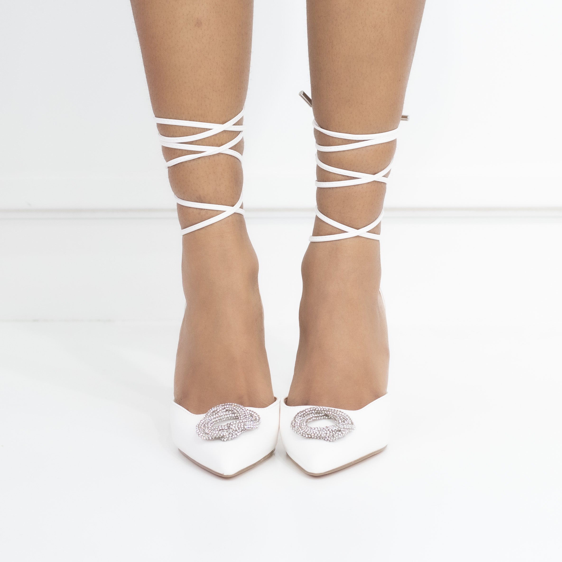 White tie up pointy heel with a round diamond trim cupid