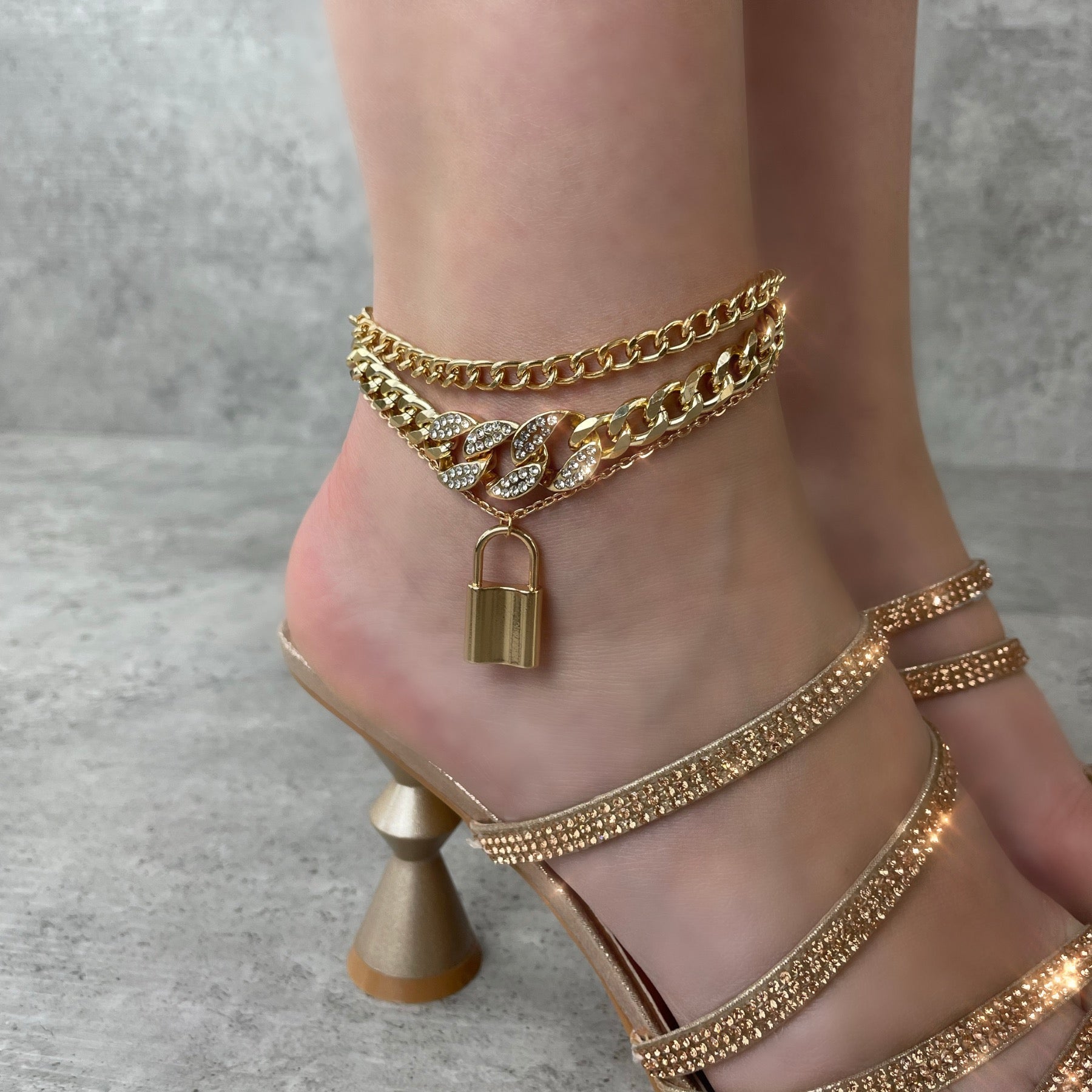 Ankle lock 3-piece bedazzled gold anklet.