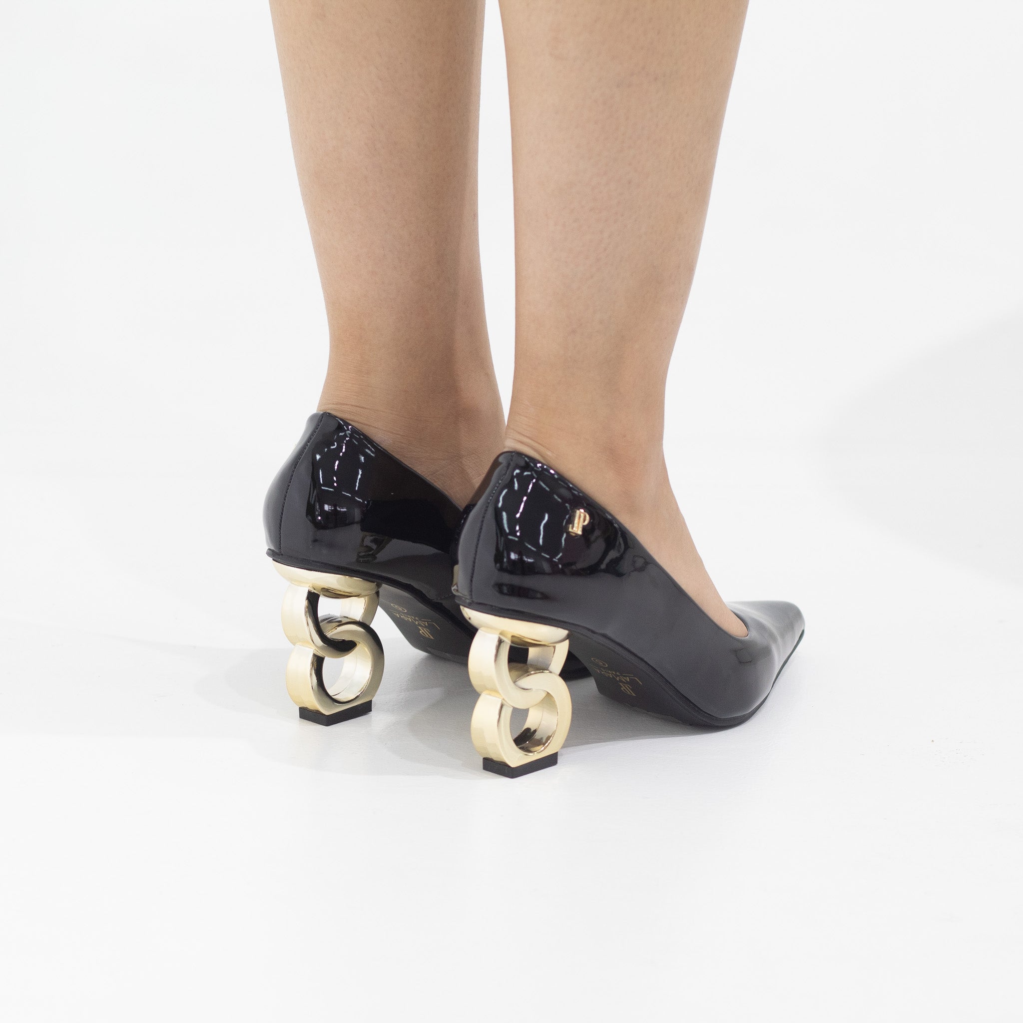 Black shoe with gold circle heel