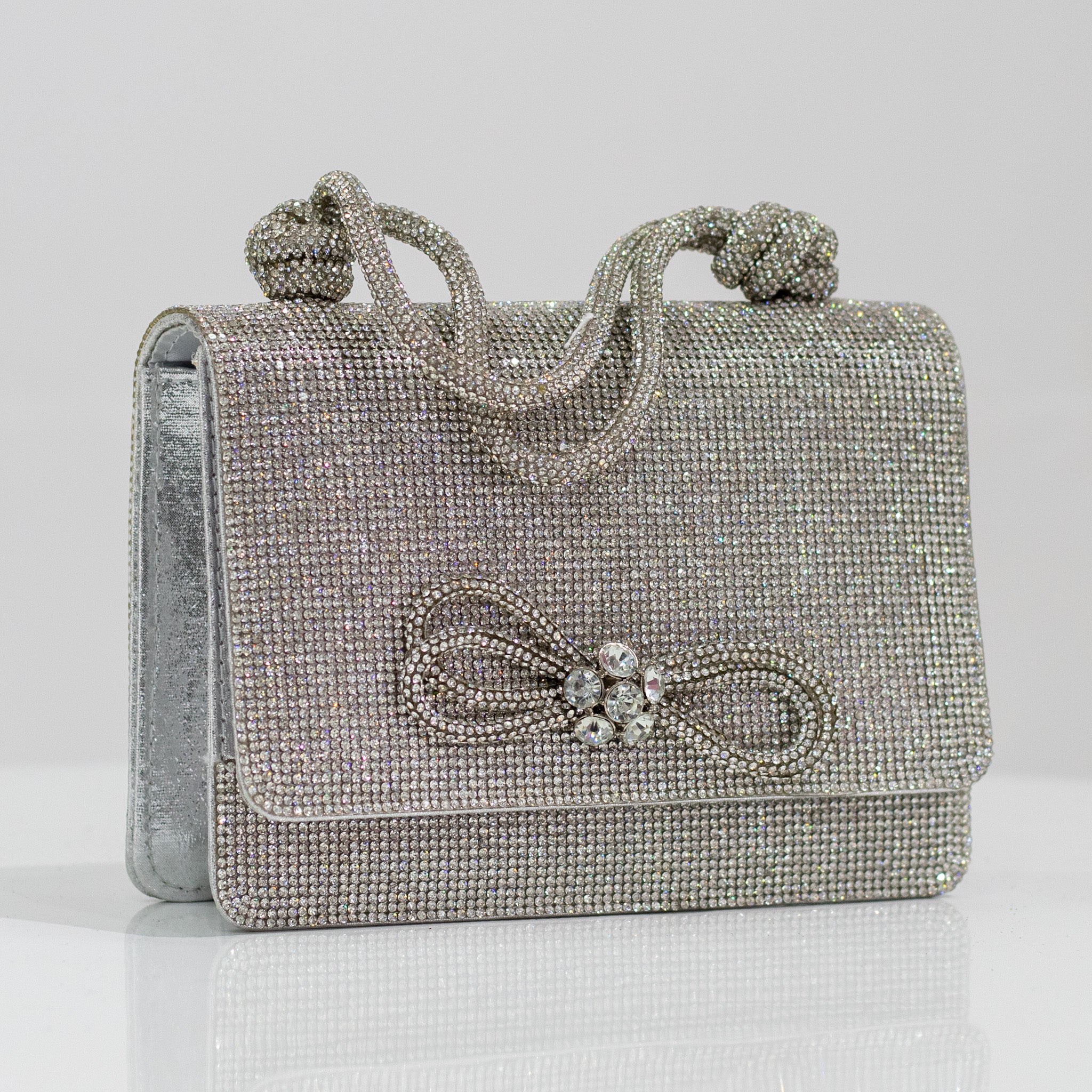 Silver bow detail diamante clutch bag xion